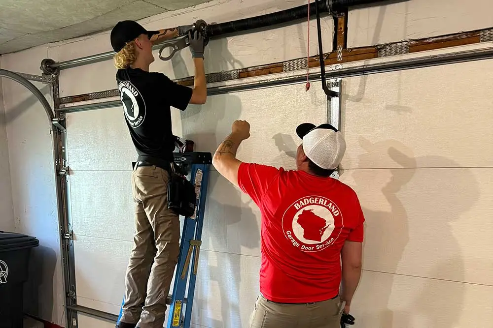 broken-springs-3 team working on Garage Door Spring Repair