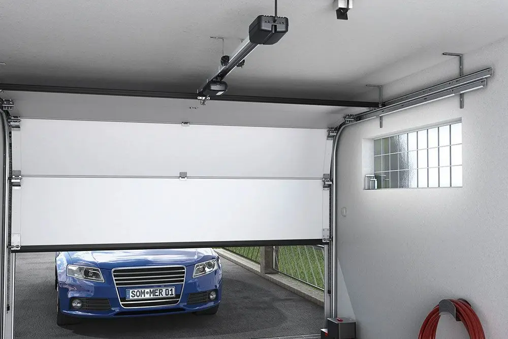 sommer-garage-door-opener A blue car parked outside a half-open garage door, showcasing a repair service in Appleton.| Badgerland Garage Door Service – Green Bay Garage Door Repair