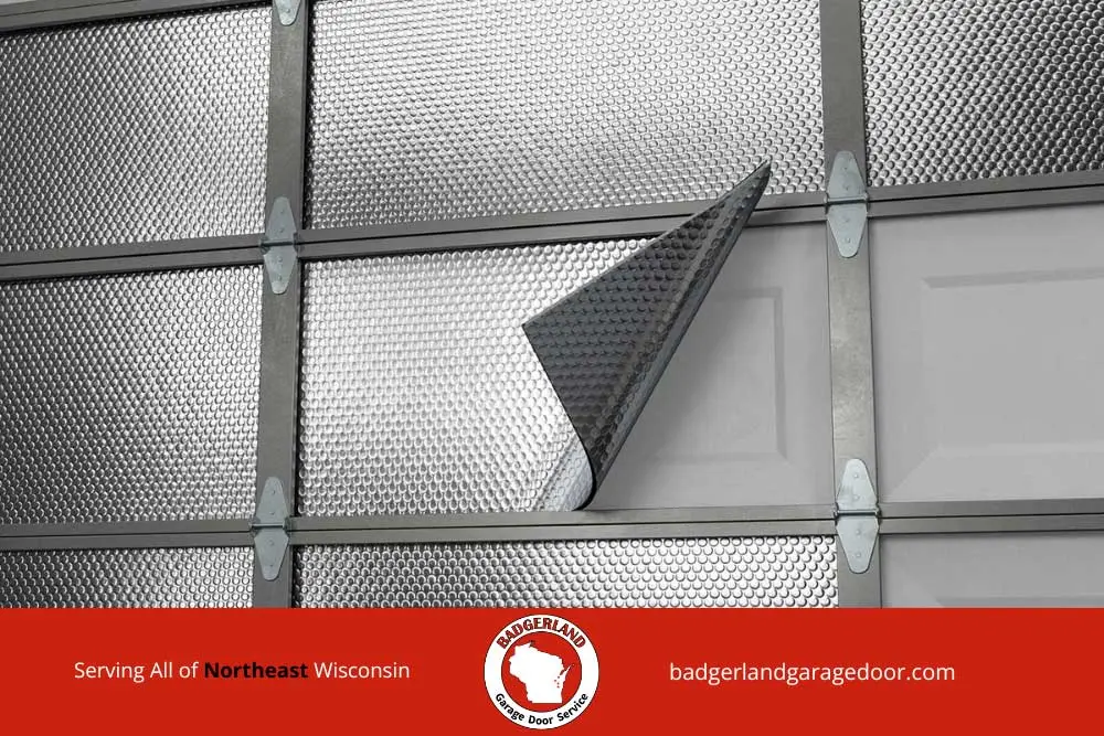 Reflective insulation material being applied to a garage door interior to improve energy efficiency and comfort.