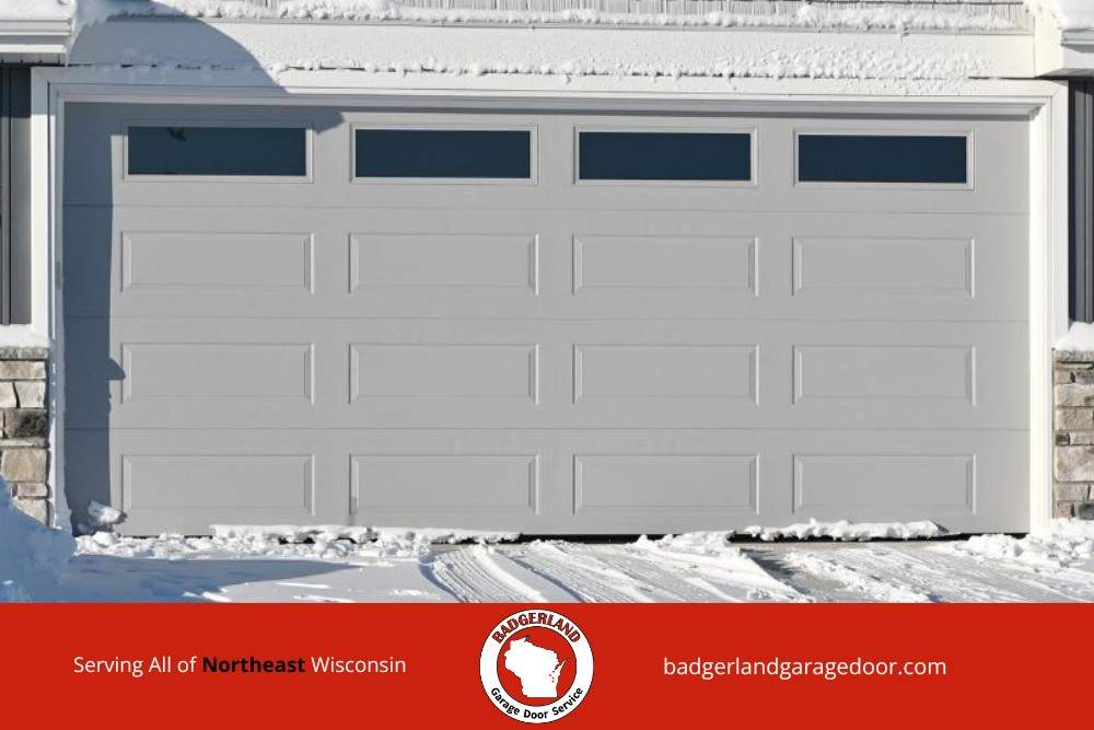 Snow covered Wisconsin garage door demonstrating winter conditions Badgerland Garage Door provides service to protect with weatherproofing.
