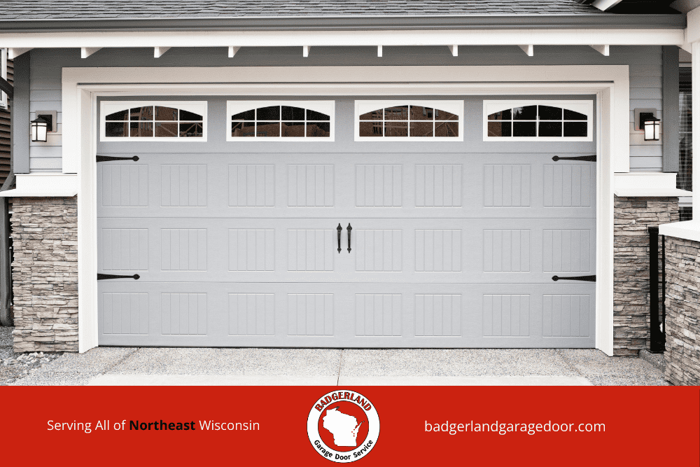 A modern garage door with stone accents, promoting Badgerland Garage Door Repair services in Appleton and Green Bay.| Badgerland Garage Door Service – Green Bay Garage Door Repair